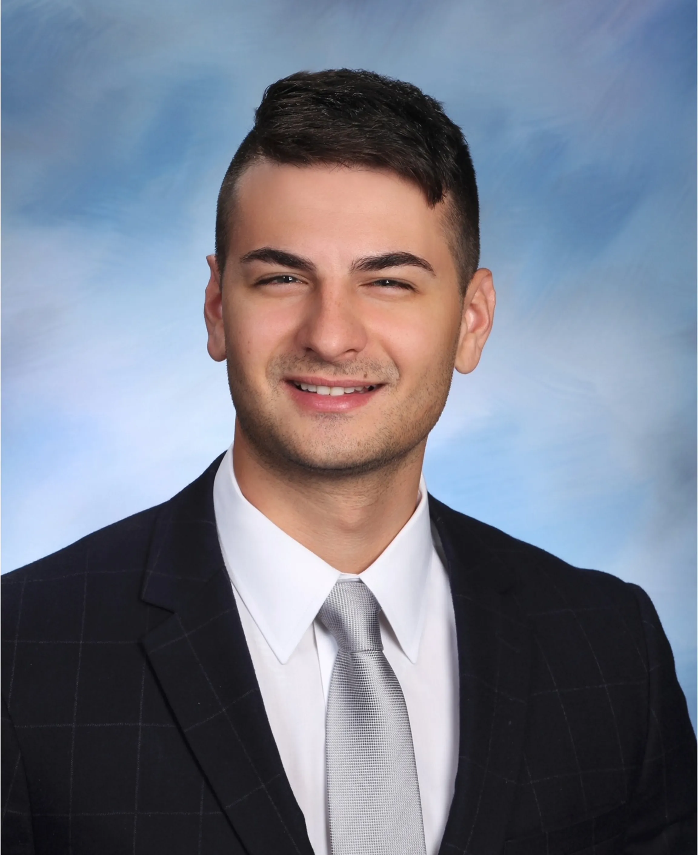 Man in suit with a light background.