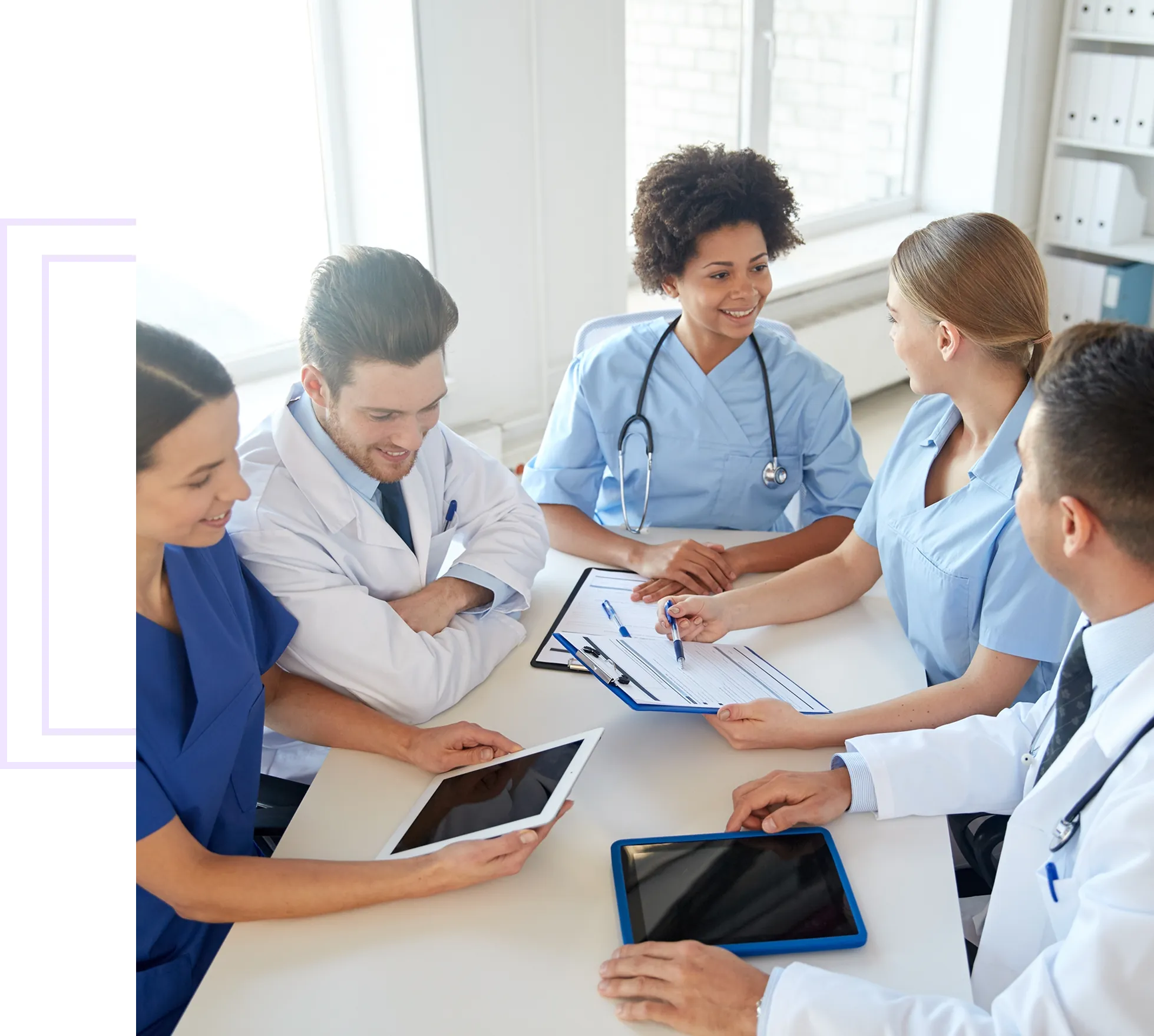 Medical team discussing with digital tablets.