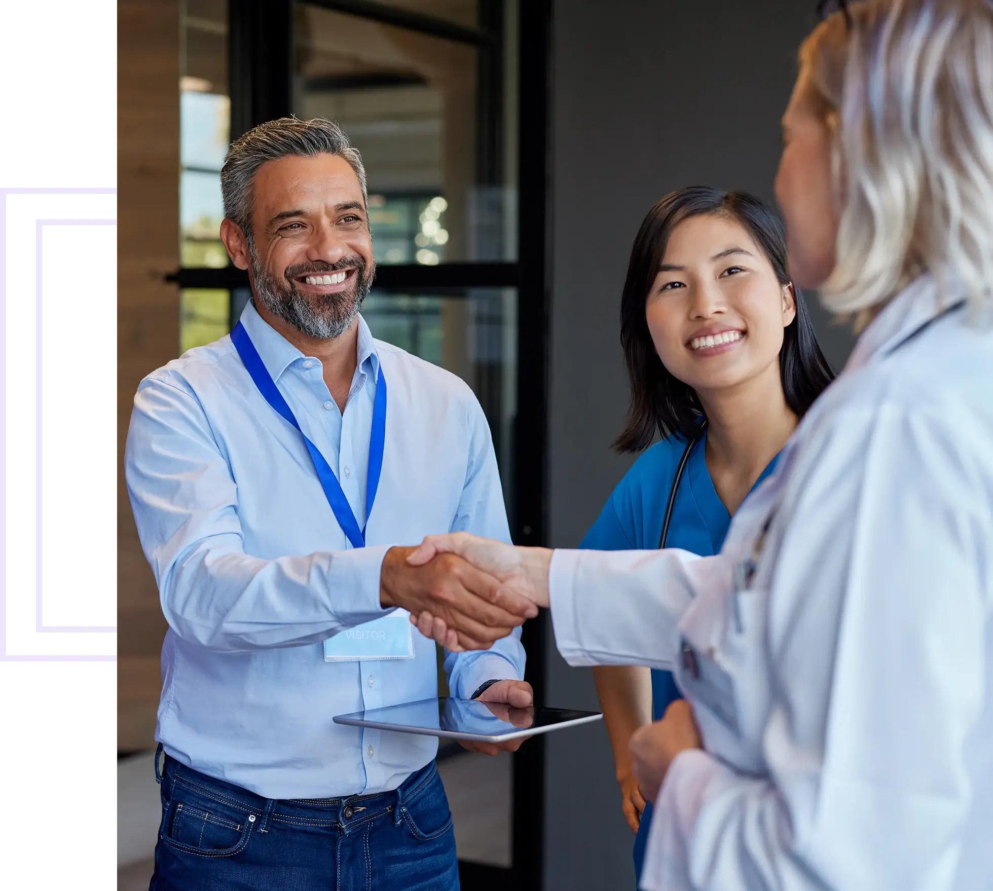 People shaking hands in a professional setting.