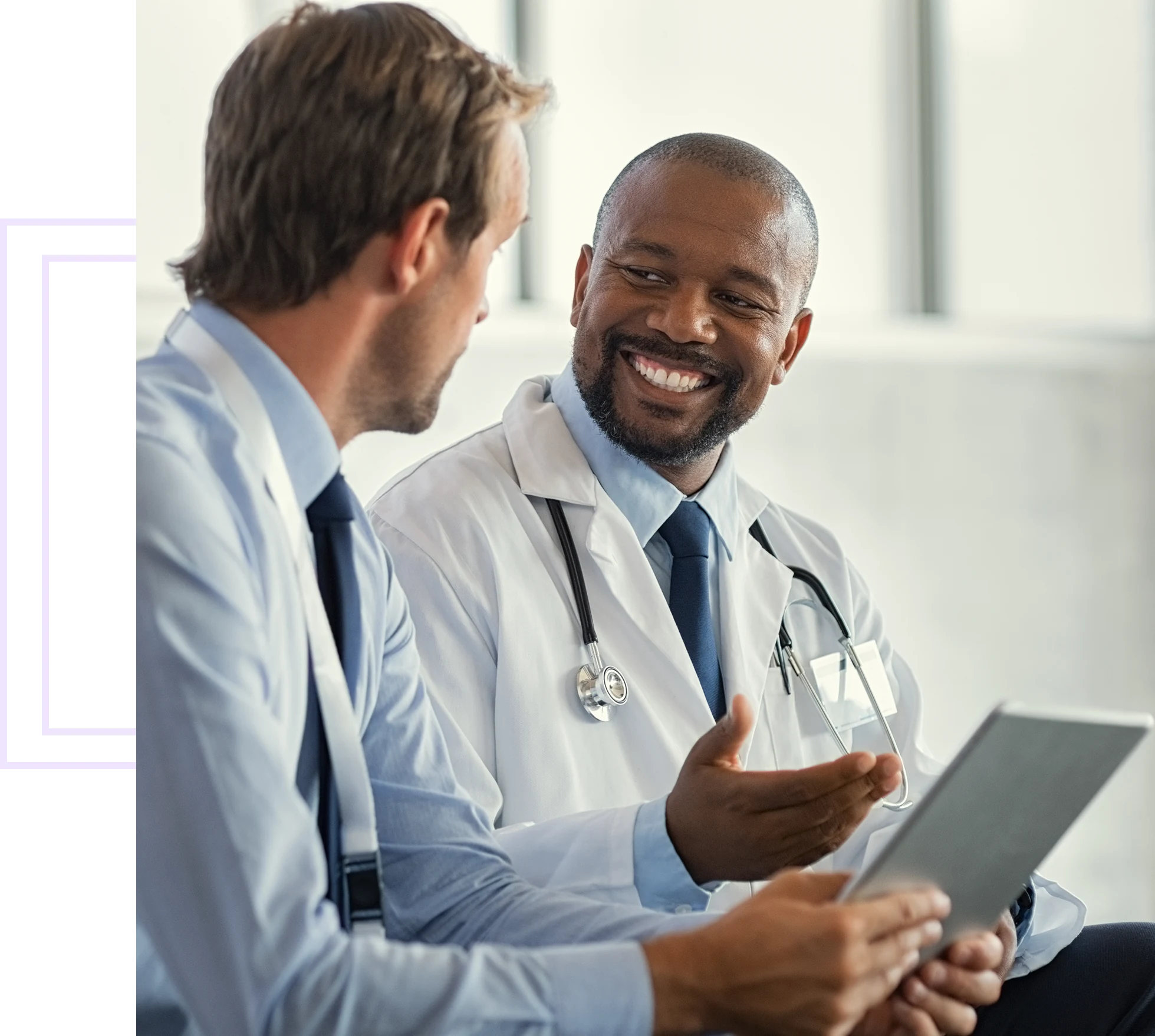 Two doctors discussing with digital tablet.