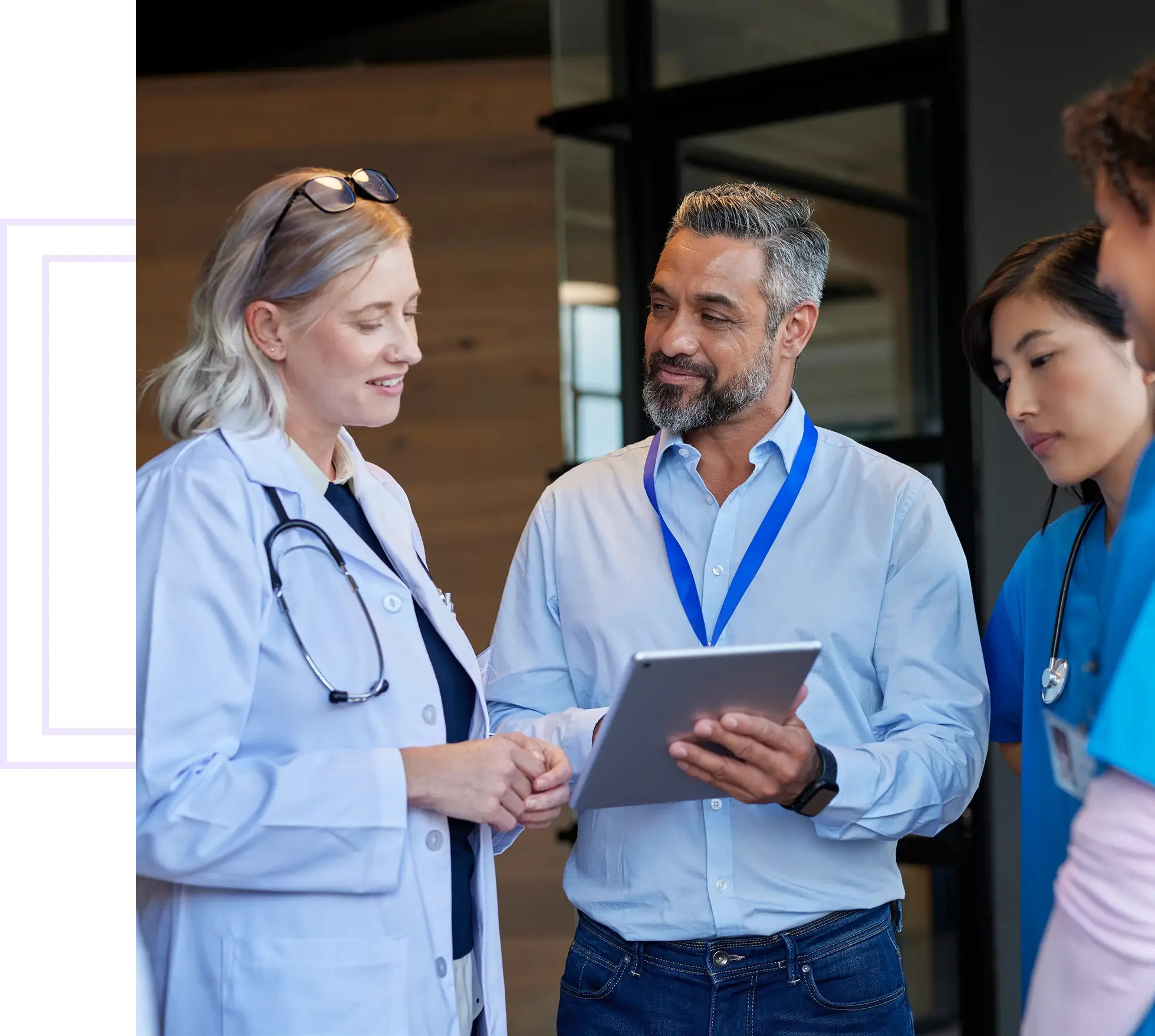 Doctors and staff discussing with digital tablet.