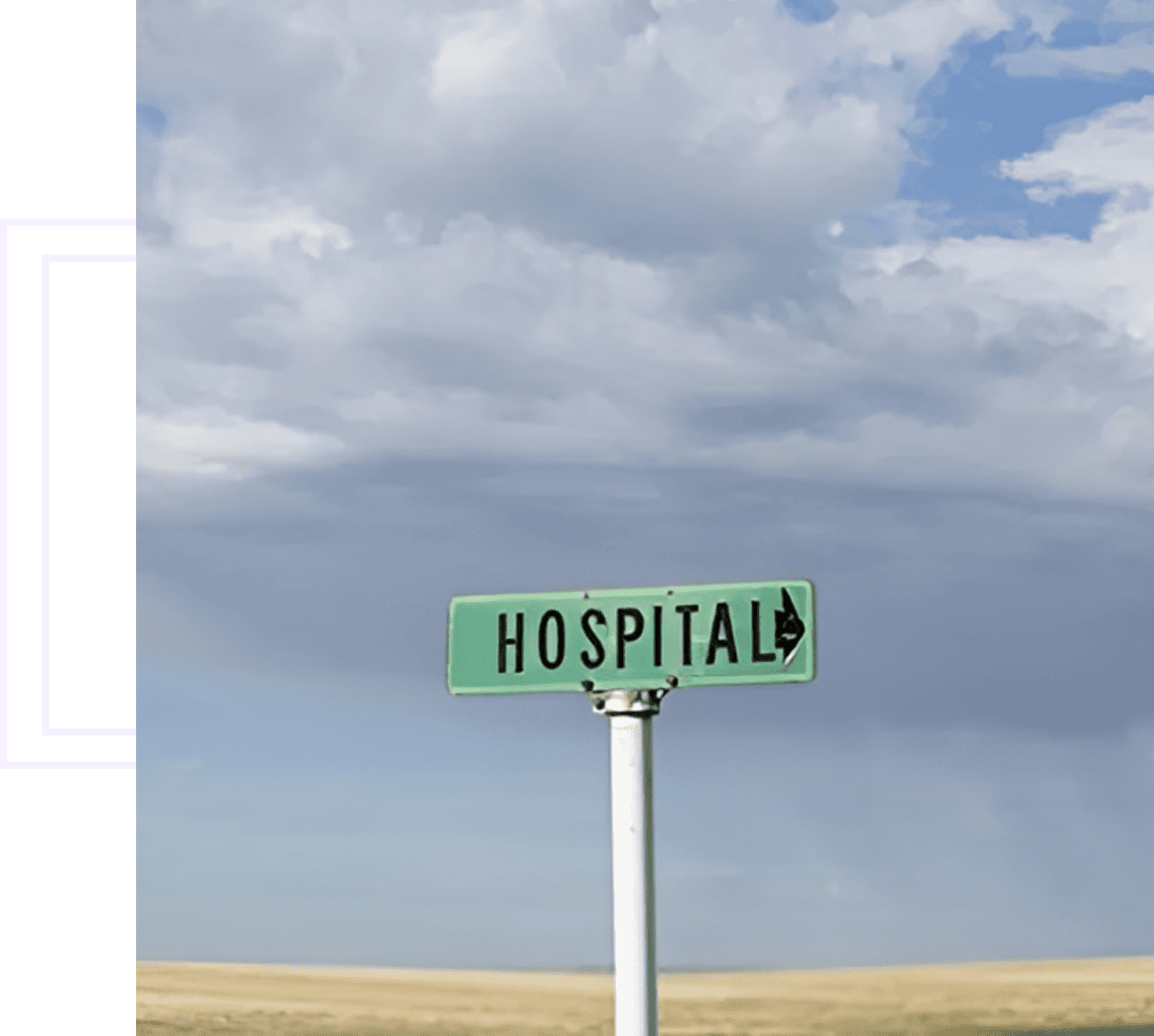 A green hospital direction signpost under a cloudy sky.