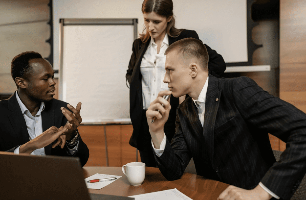 A man in a suit attentively listens during a business meeting.
