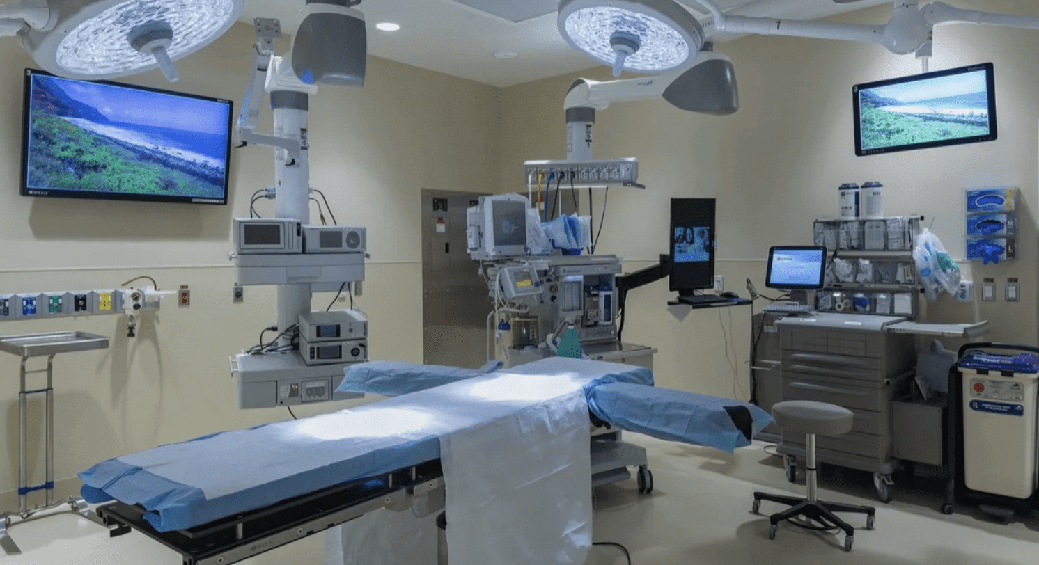 A modern operating room with surgical equipment and monitors.